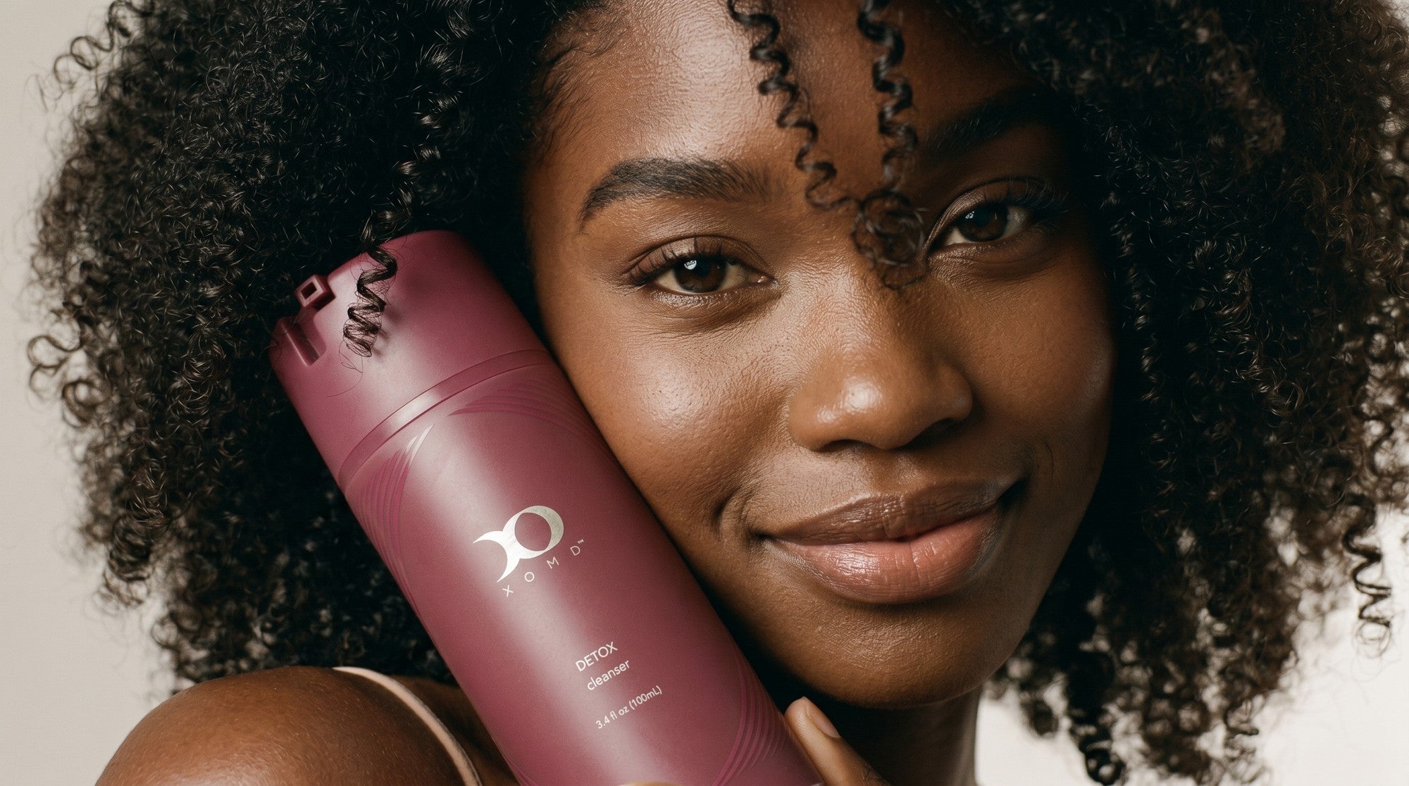 Woman holding XOMD Detox skincare