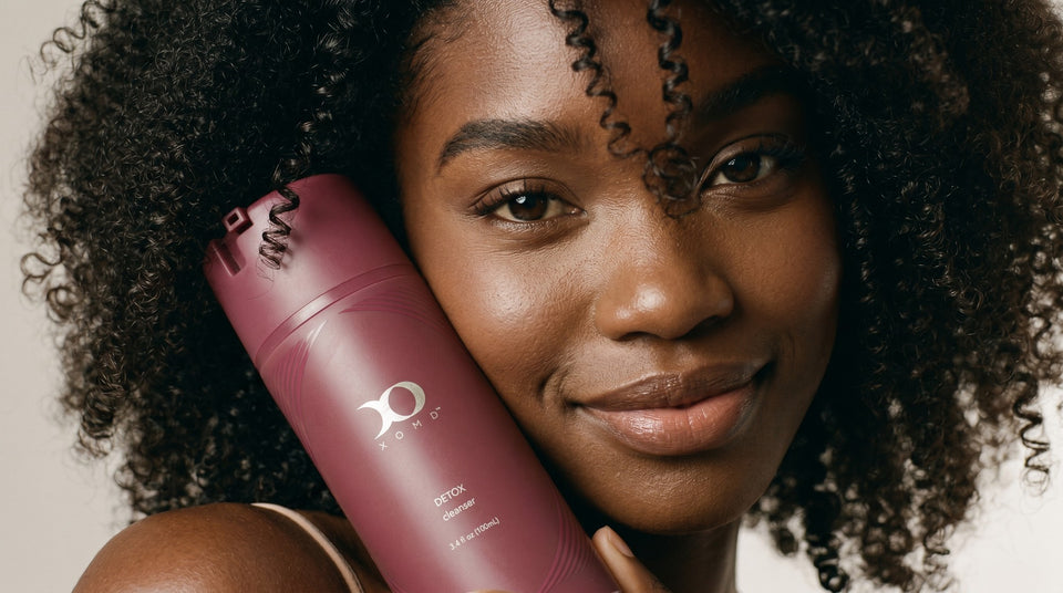 Woman holding XOMD Detox skincare